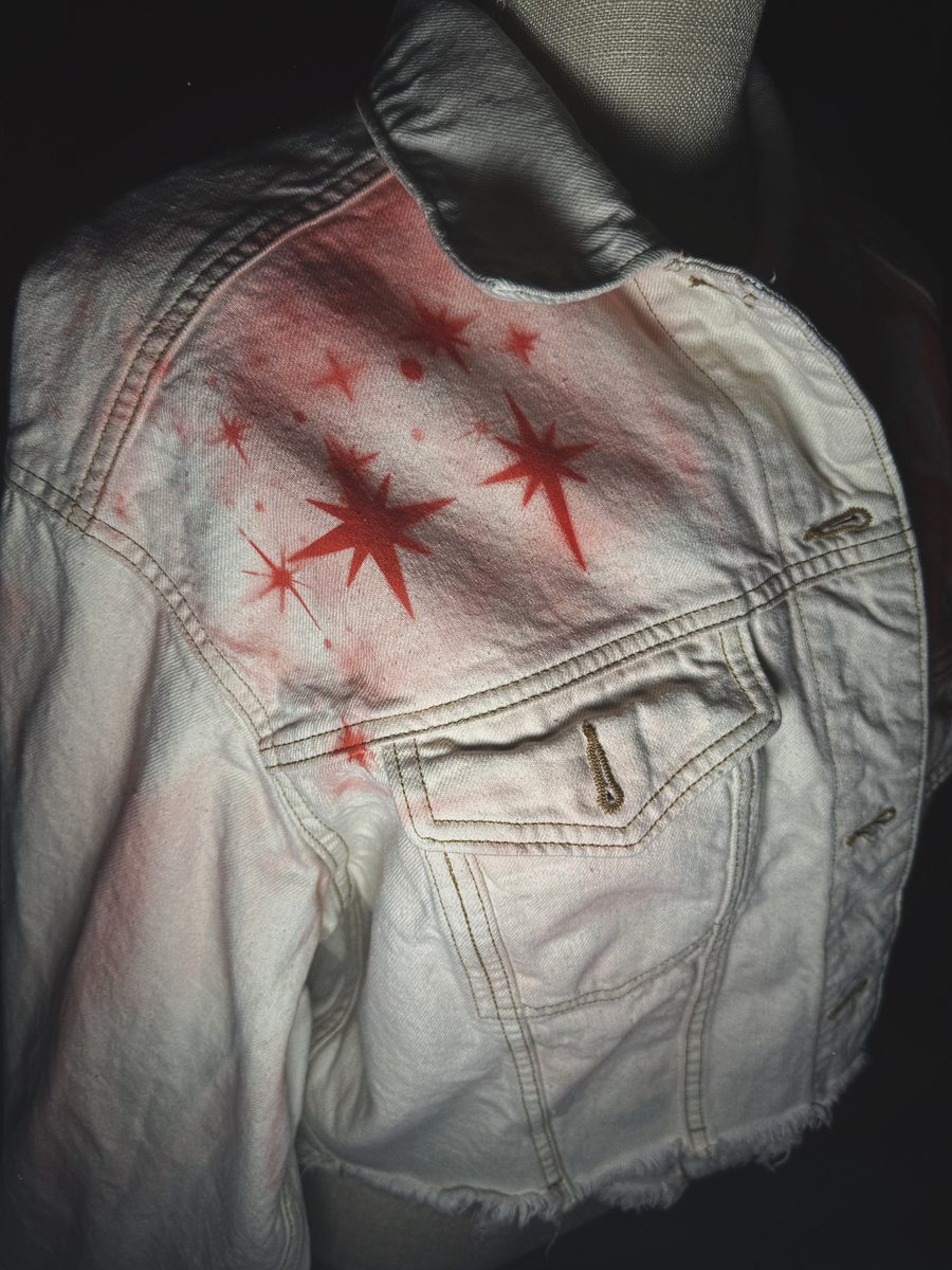 Airbrushed red stars on white denim