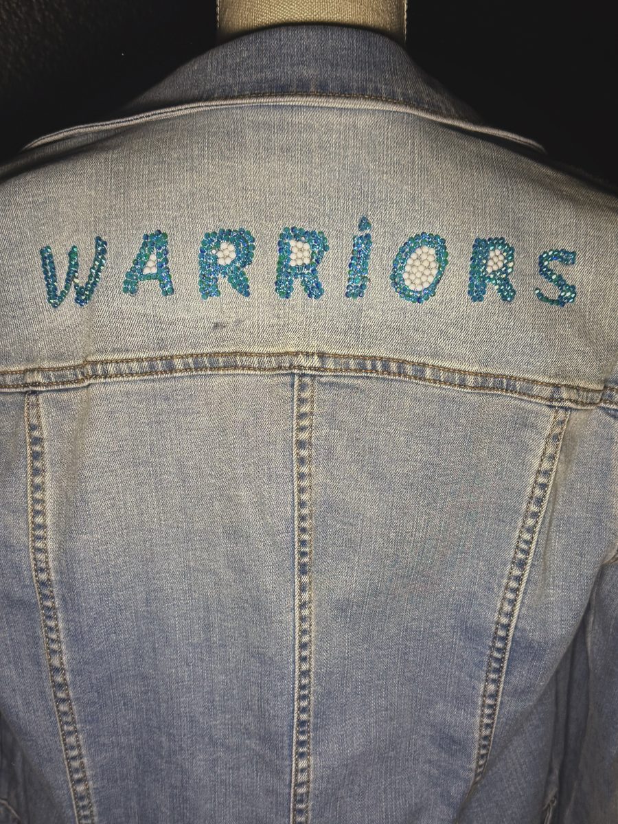 Warriors hand-beaded across the back of a denim jacket
